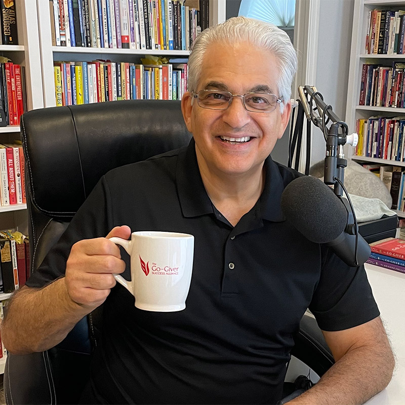Bob Burg seated in his office with a Go-Giver mug